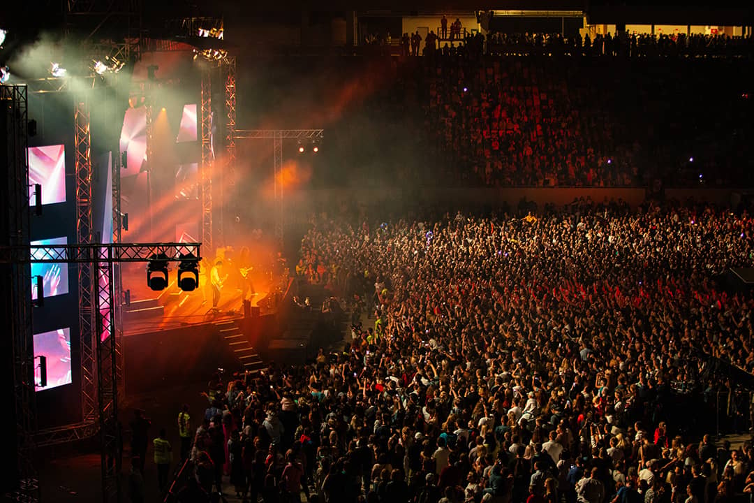 A sold out stadium during a concert performance.